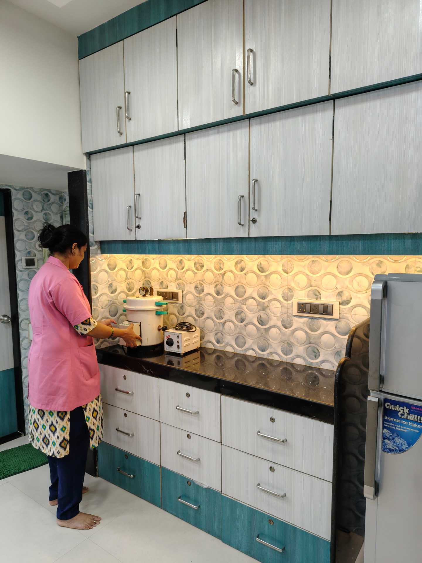 Clinic staff operating sterilisation equipment at Rachana's Dental Clinic