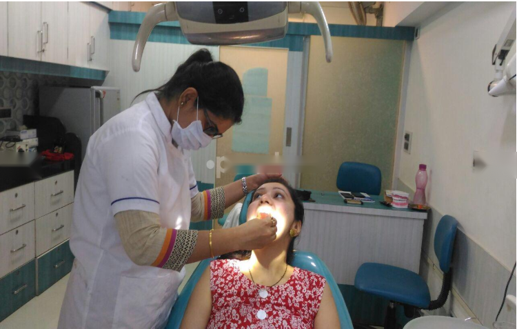 Dr. Rachana Verma treating a patient at Rachana's Dental Clinic